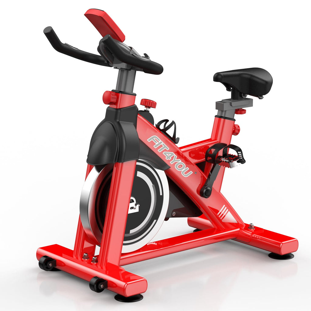 Red fitness bike with black seat and handlebars on a white background