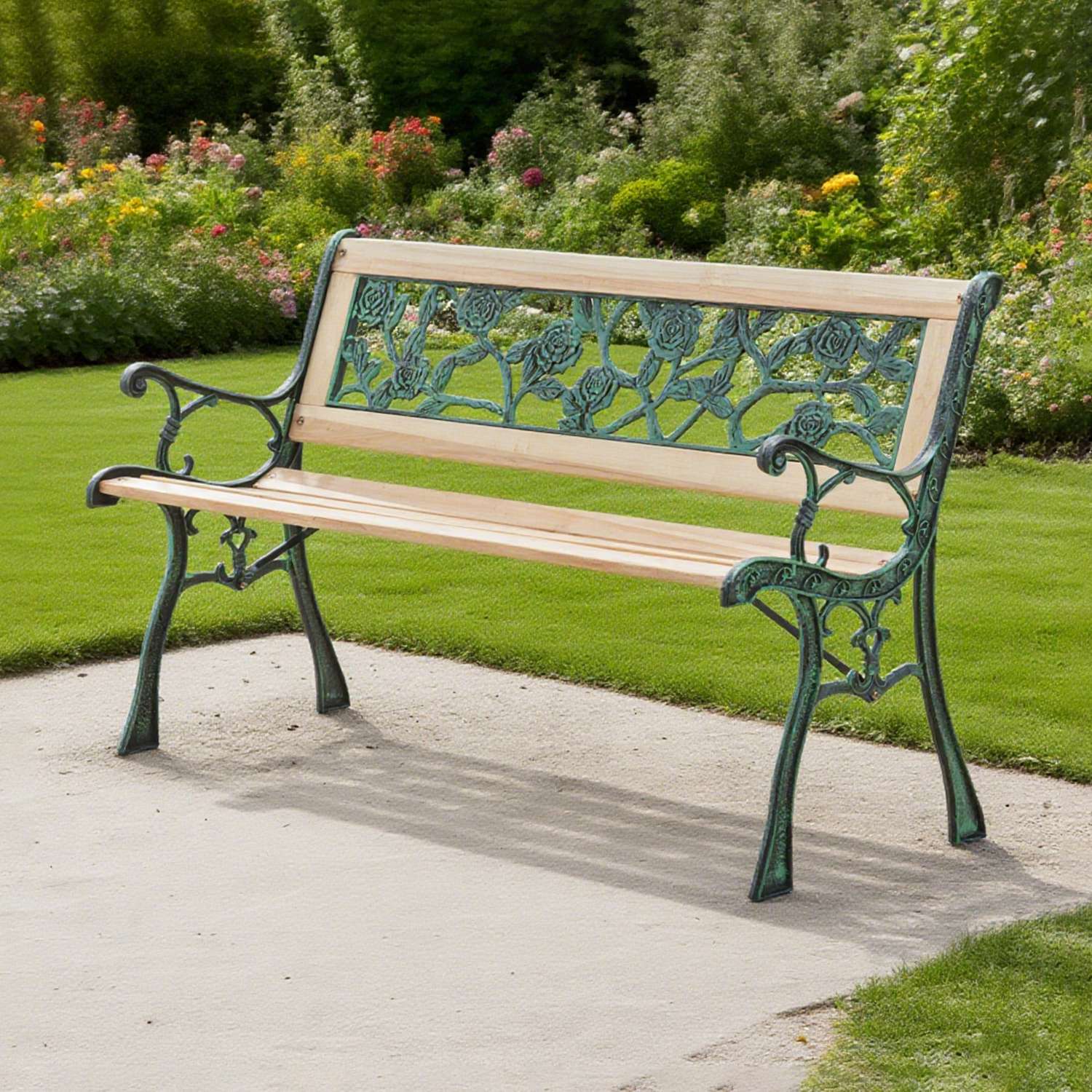 Wooden garden bench with rose metalwork on a paved path with a garden background.