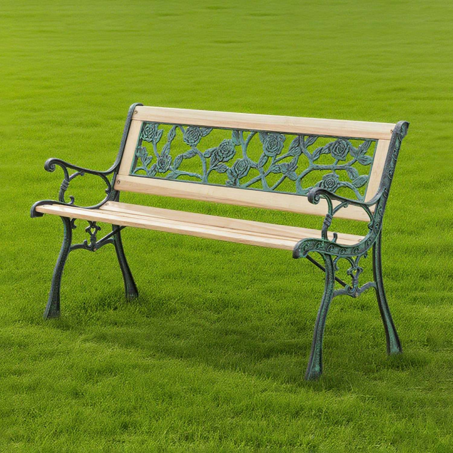 Wooden garden bench with decorative metal armrests and backrest on a grassy field