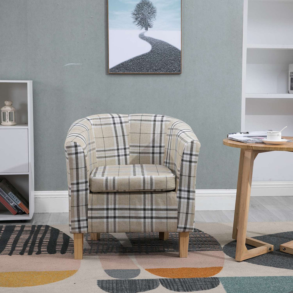 Cream checkered tub chair in a living room setting with a table and wall art.