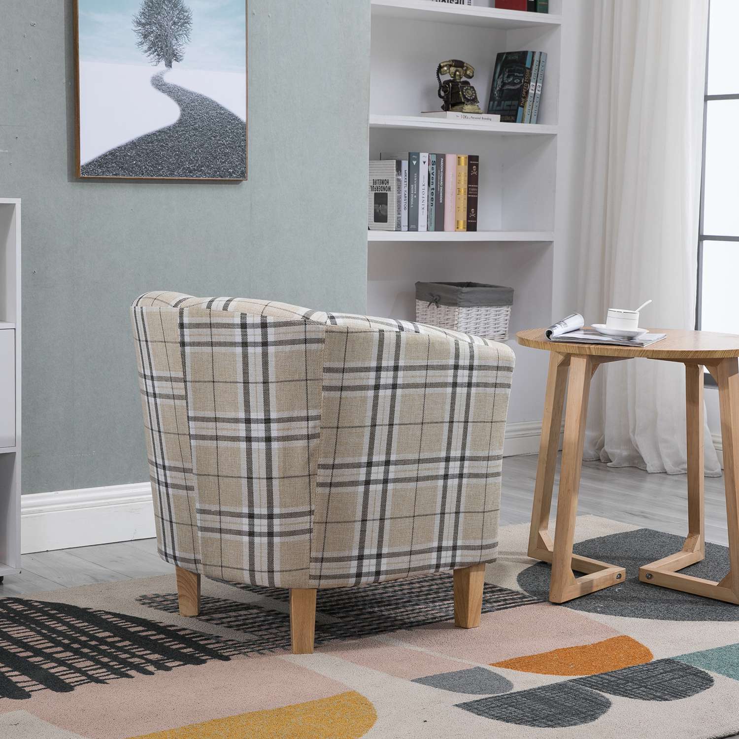 Cream checkered tub chair in a room with a bookshelf and small table.