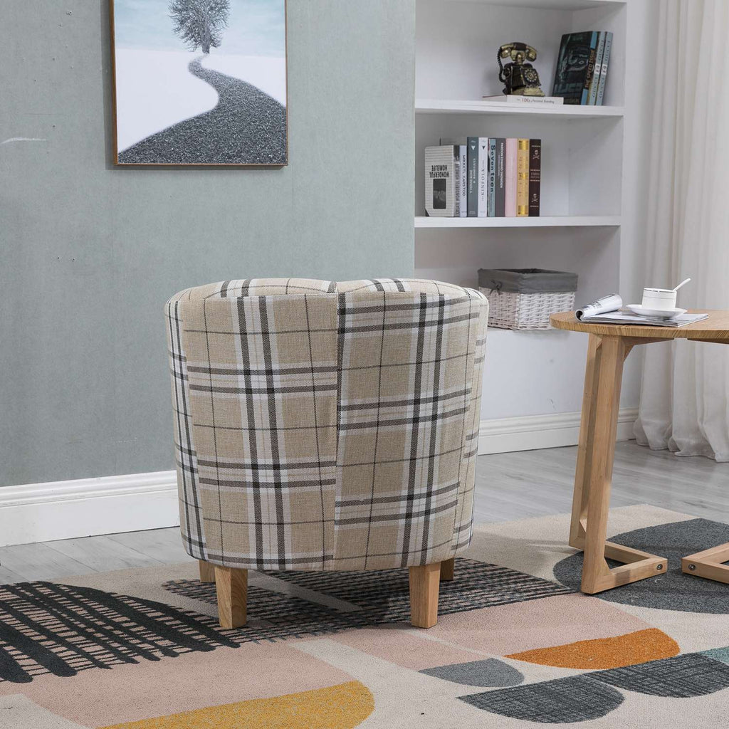 Cream checkered tub chair in a room with a bookshelf and colorful rug