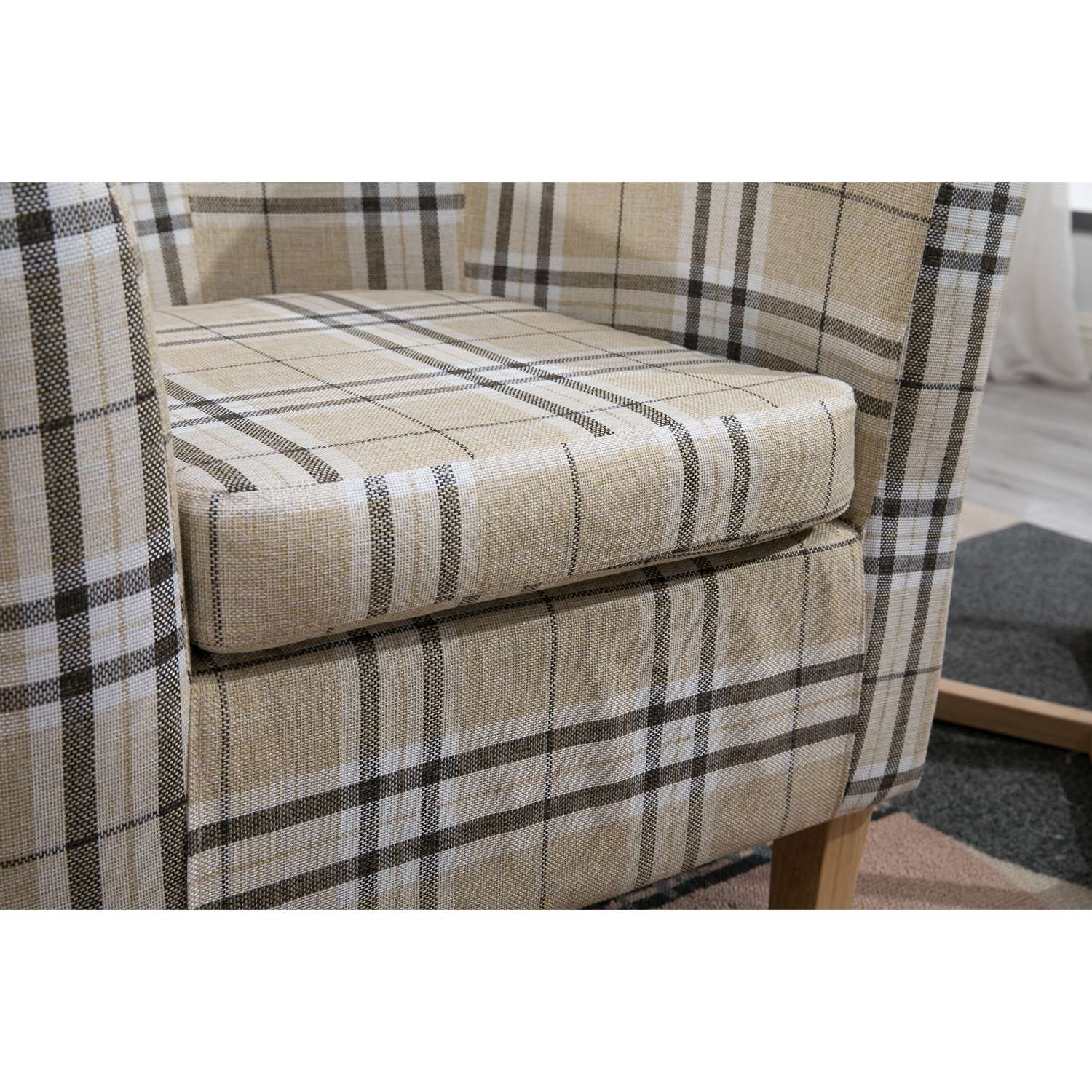 Cream checkered tub chair with a neutral color scheme