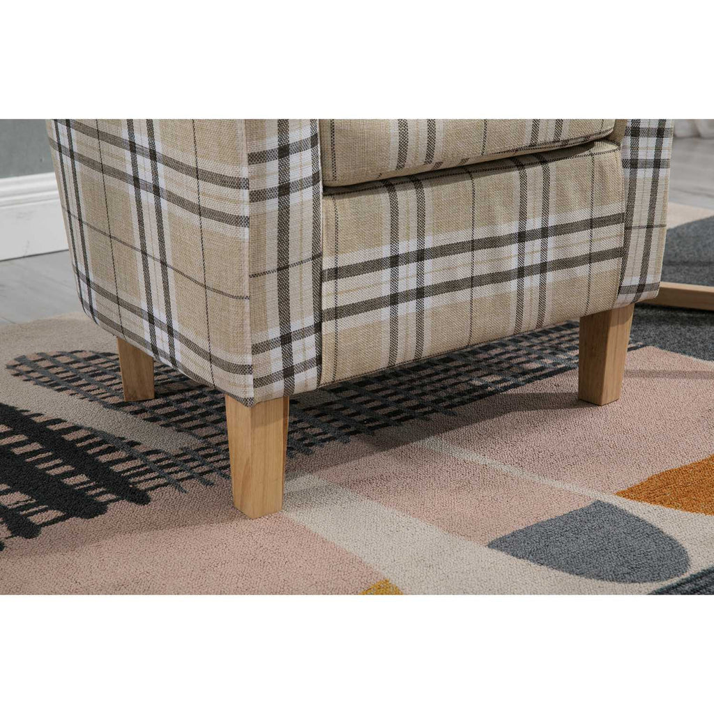 Cream checkered tub chair with wooden legs on a geometric rug