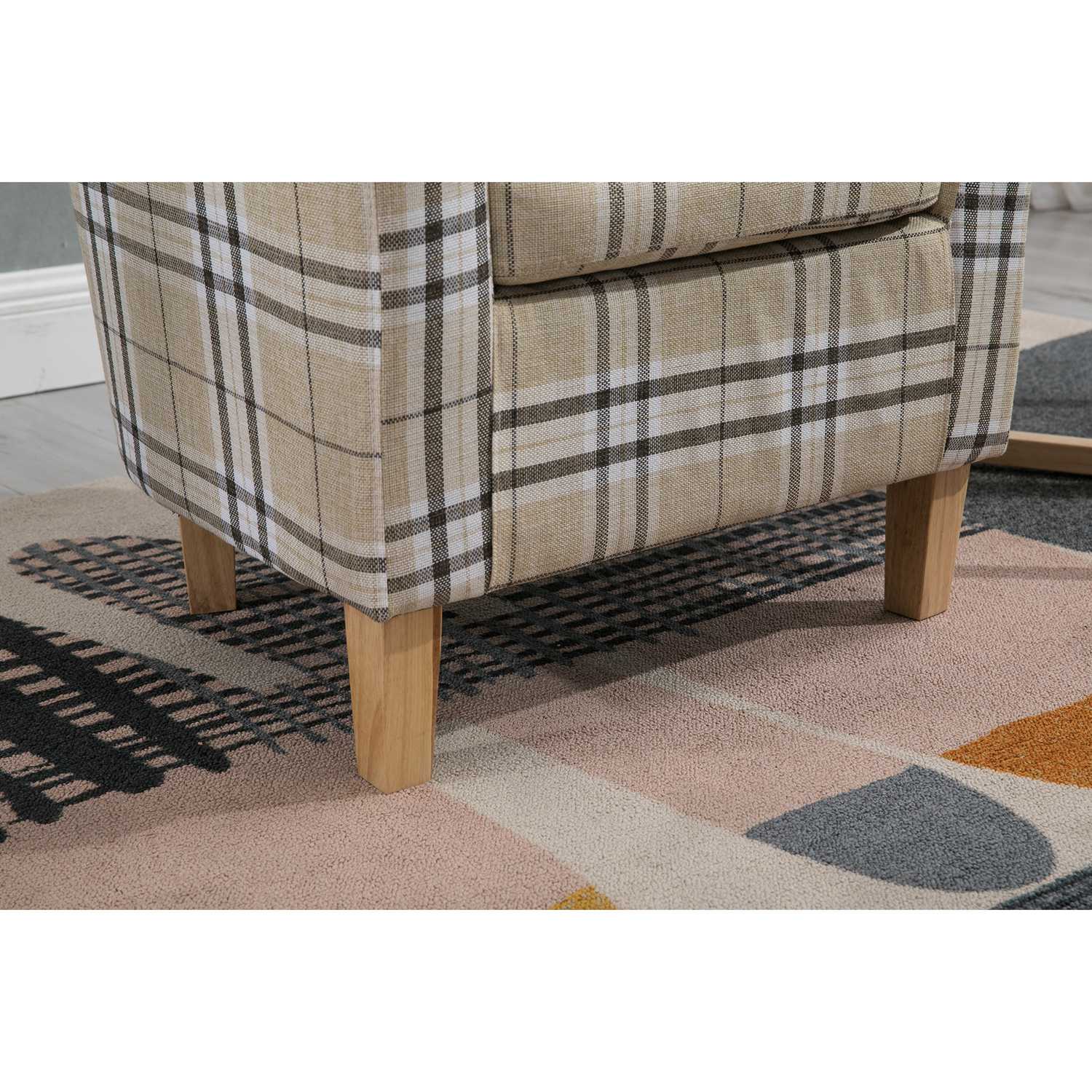Cream checkered tub chair with wooden legs on a geometric rug