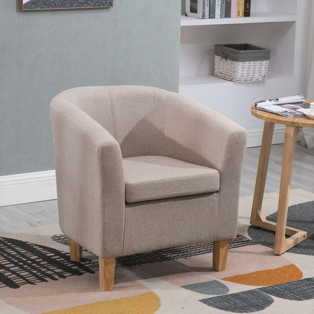 Cream tub chair in a room with a bookshelf and small table.