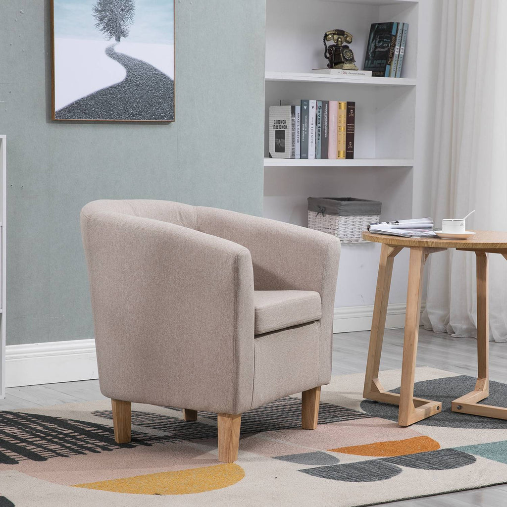 Cream tub chair in a living room setting with a bookshelf and small table.