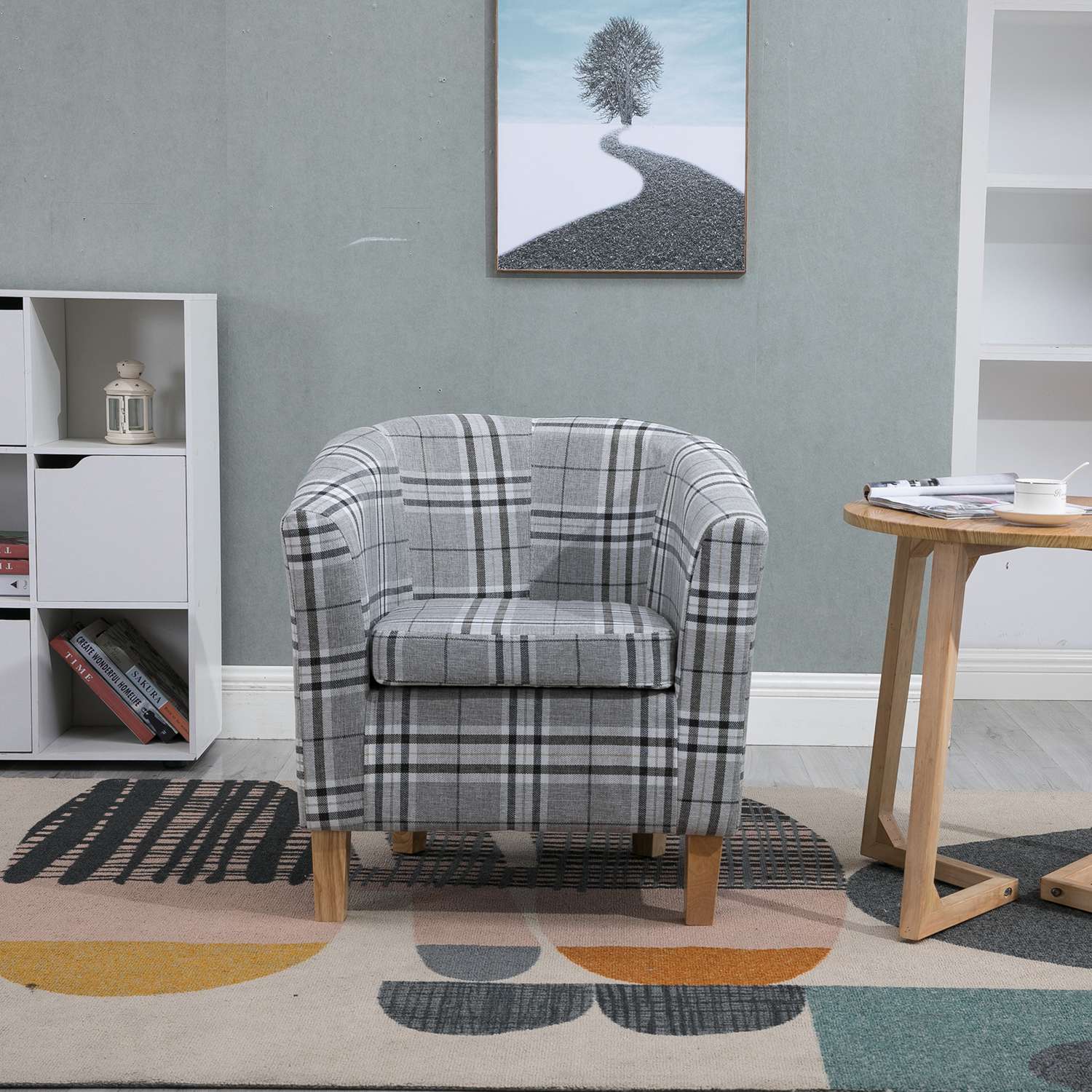 grey checkered tub chair in a room with a colorful rug and wooden side table.