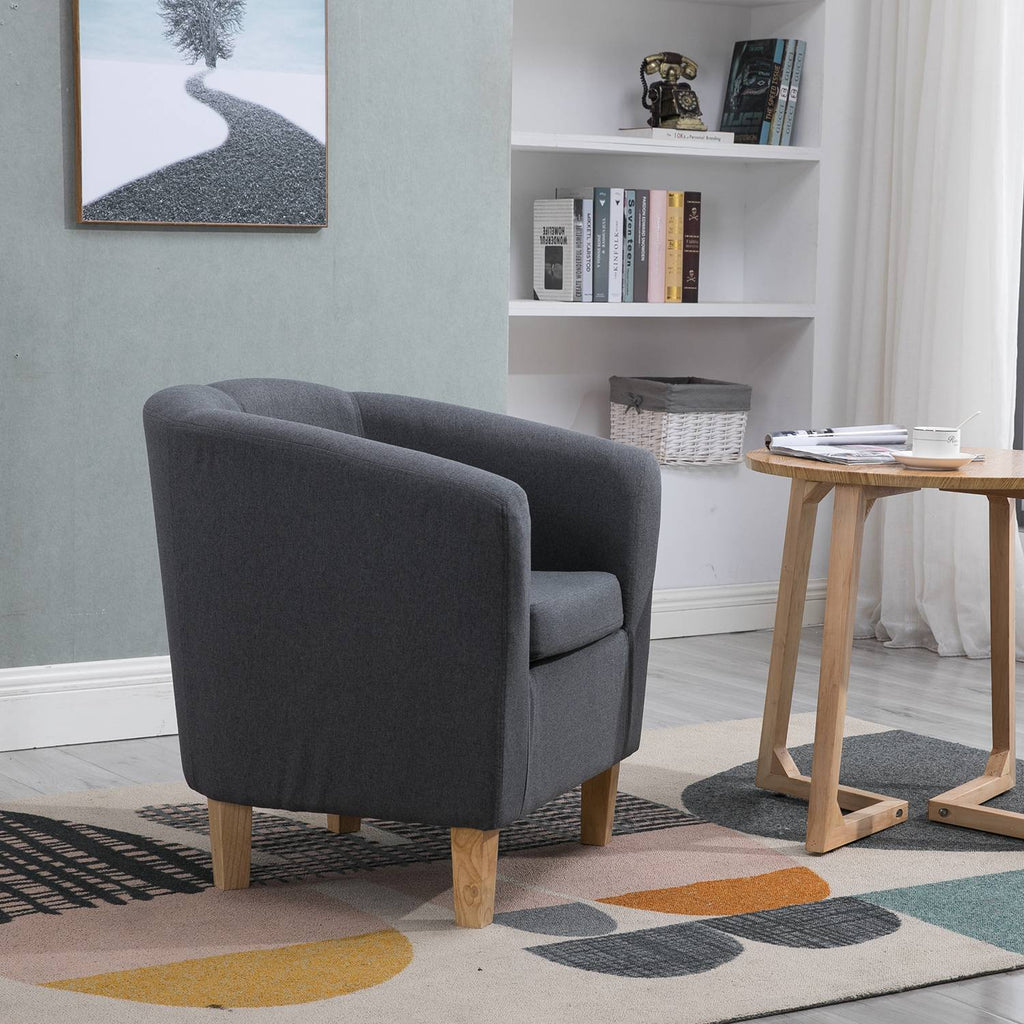 Side view of fabric grey tub chair in a living room setting.