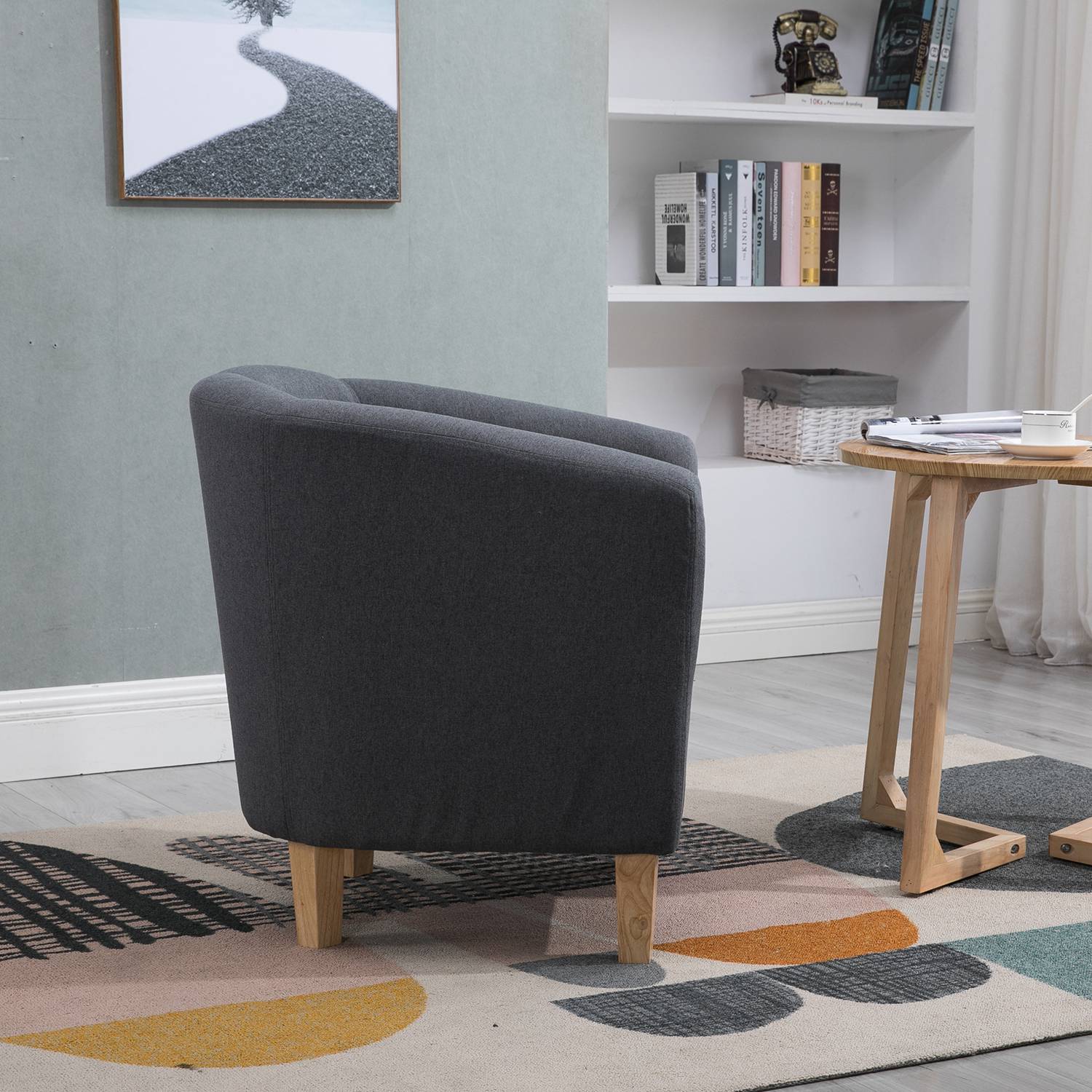 Corner view of a furniture tub chair in a living room setting.