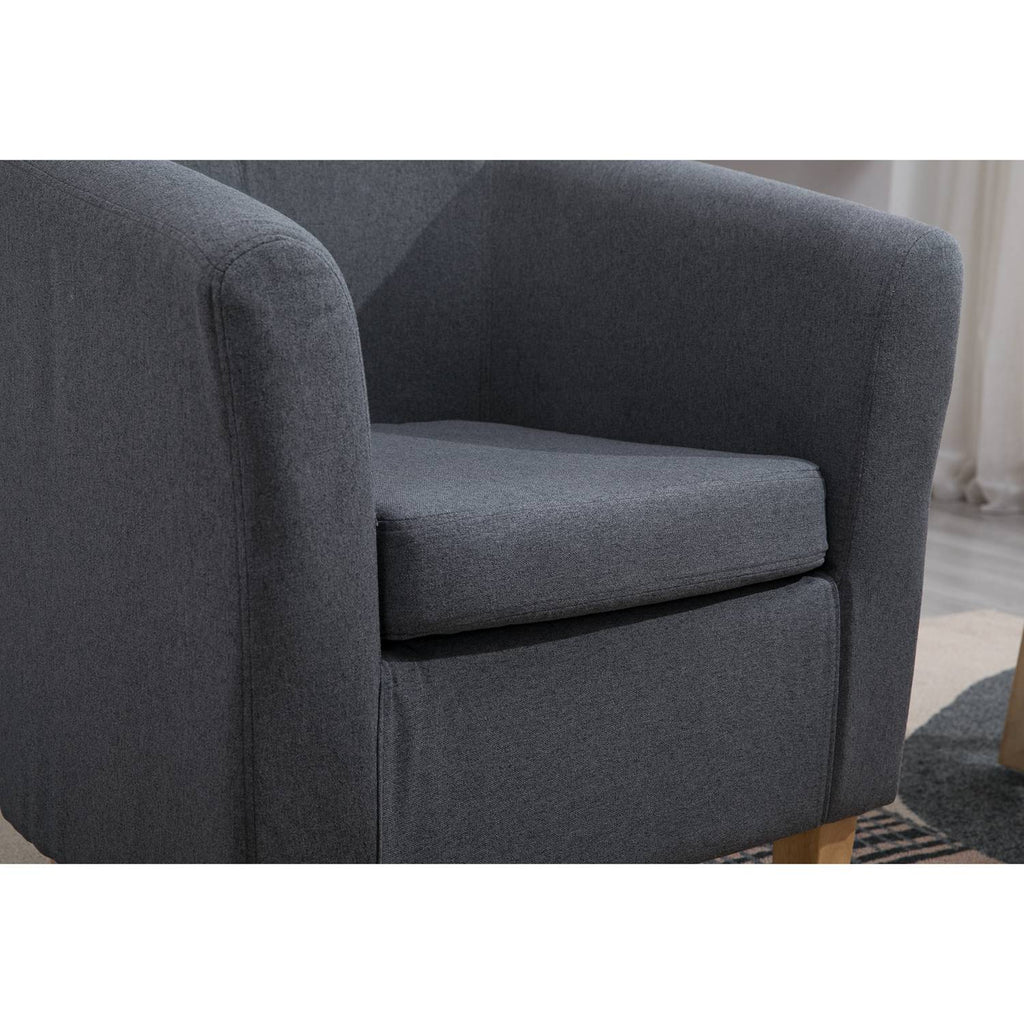 grey fabric tub chair in a living room setting. 