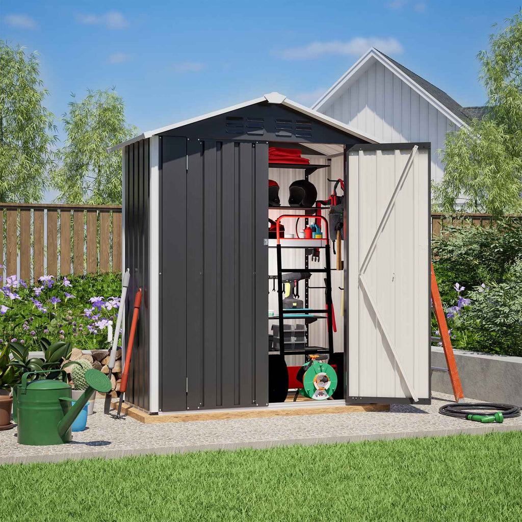 Metal garden shed with an apex roof and tools and equipment on a sunny day