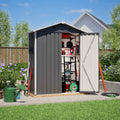 Metal garden shed with apex roof tools and equipment on a sunny day