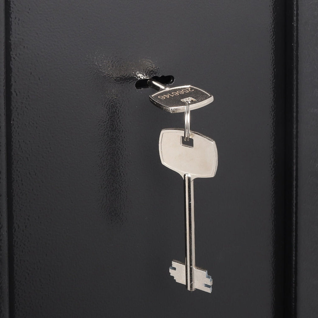 Silver gun cabinet key on a black background