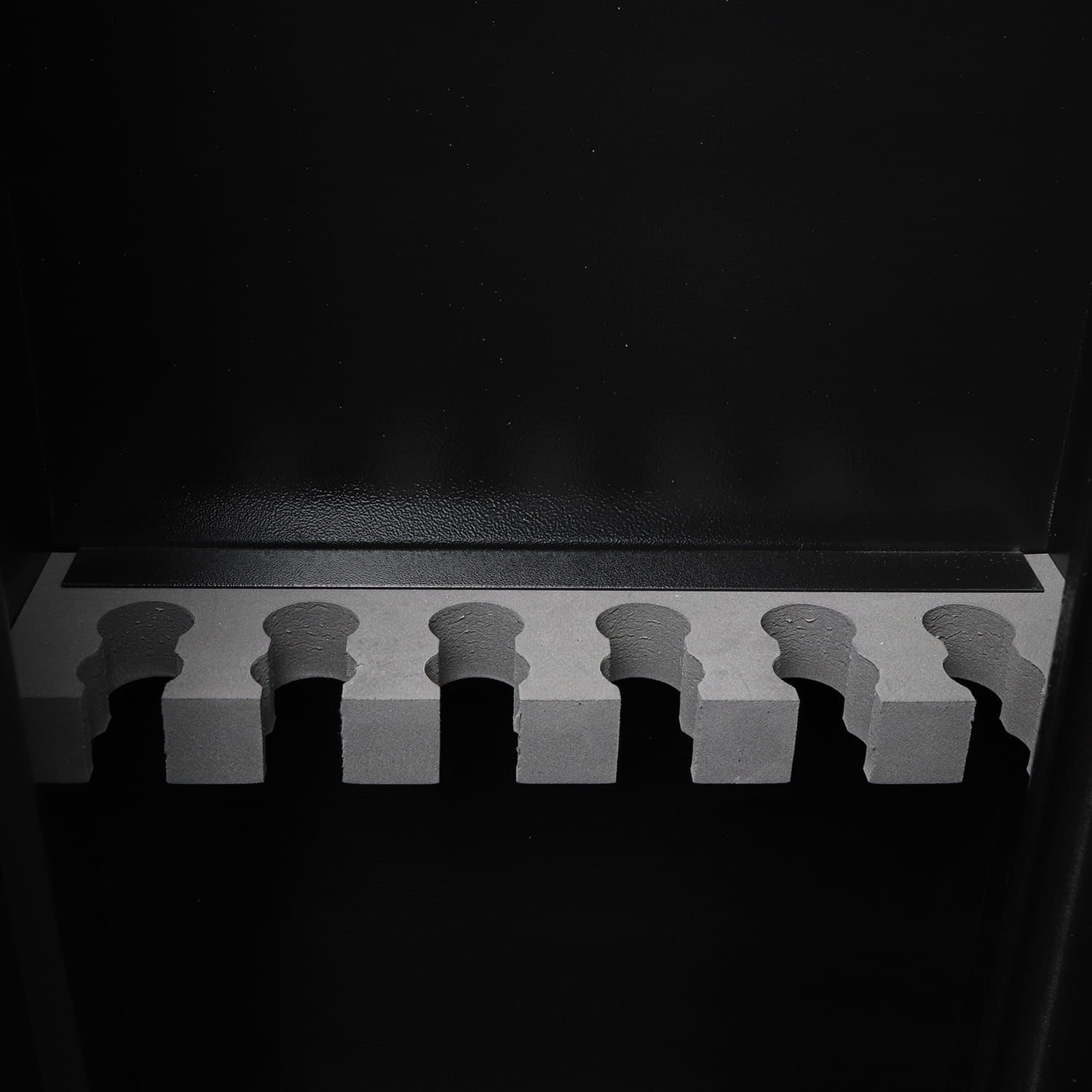 Black and white image of a foam base with a dark background