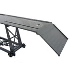 Grey motocycle lift bench metal ramp with wheels on a white background