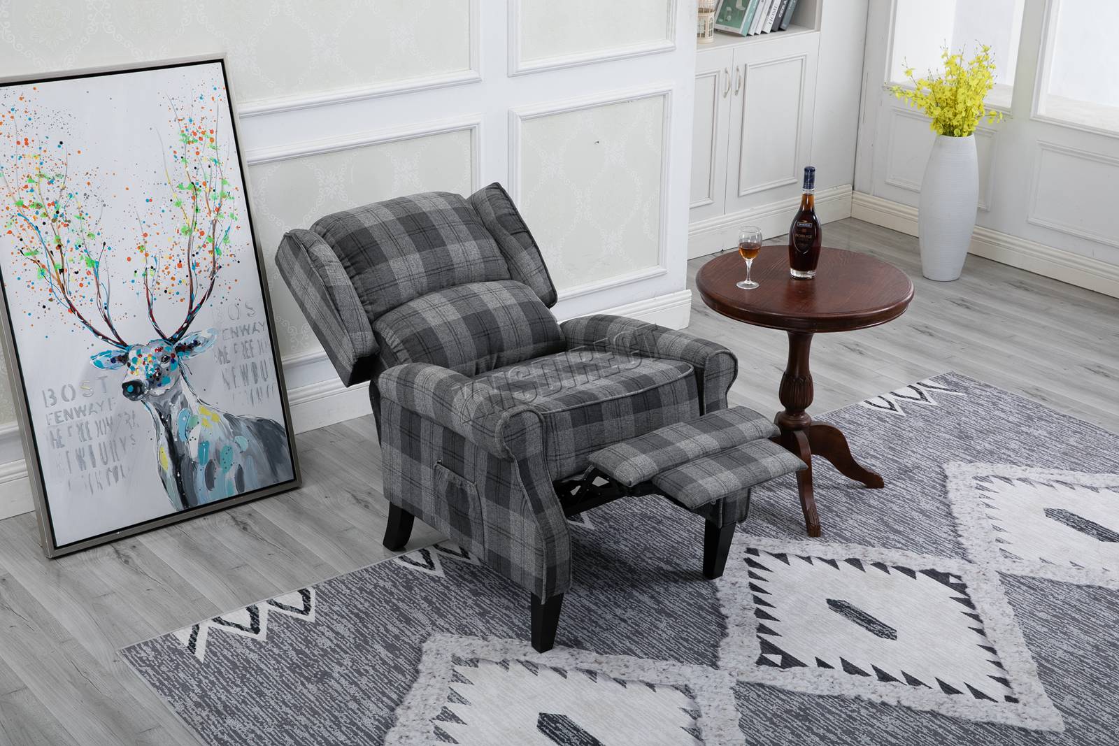Grey checkered recliner armchair in a living room with a rug and decorative items.