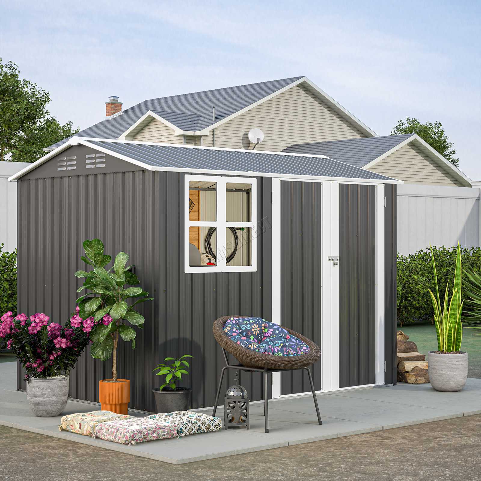 Anthracite metal garden shed with an apex roof and a white window on a small patio area featuring a chair and plants.