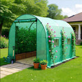 image of two section small greenhouse with plants inside in a garden background