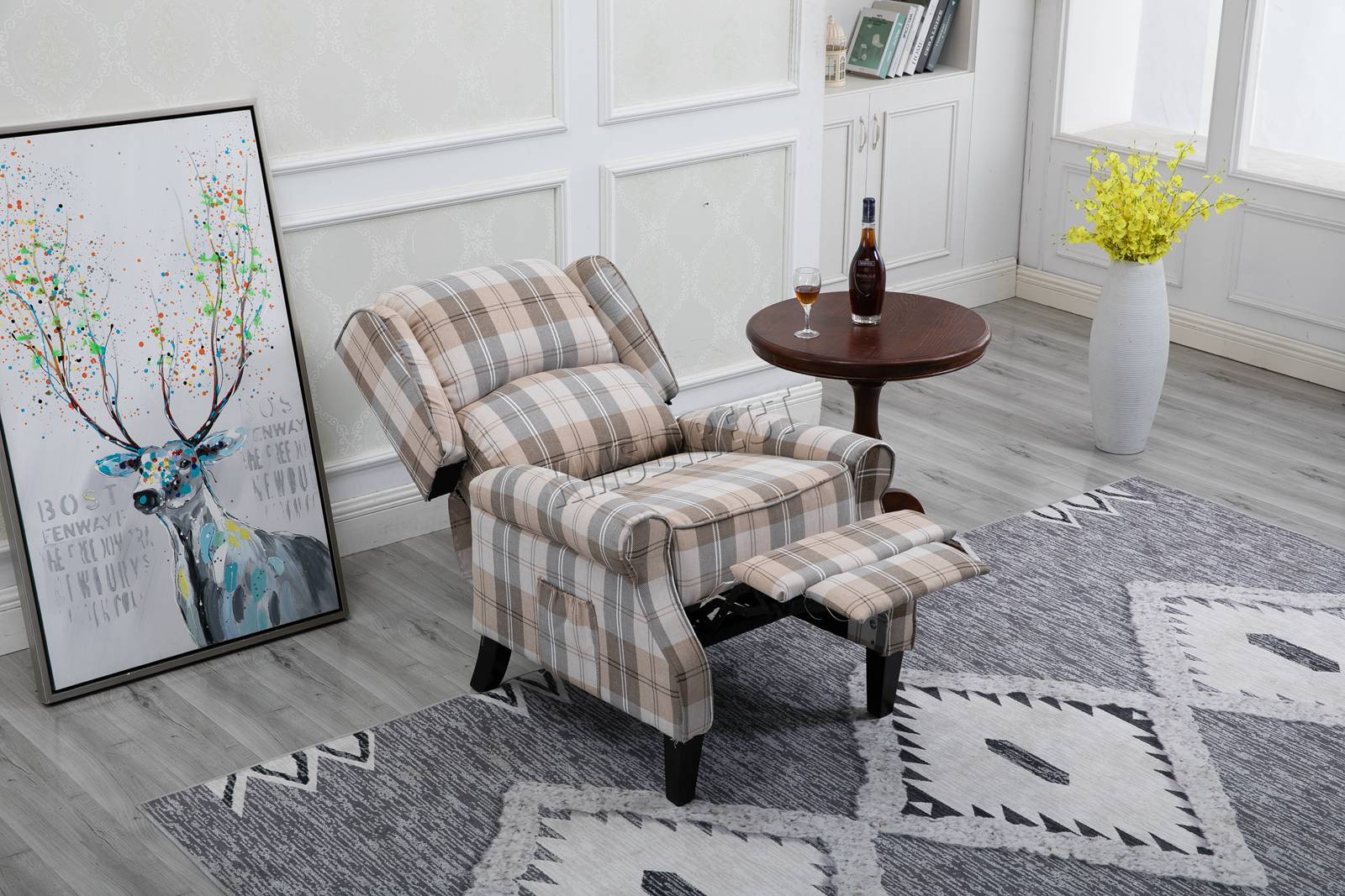 Beige checkered recliner armchair  in a room with a deer painting and a vase of flowers.