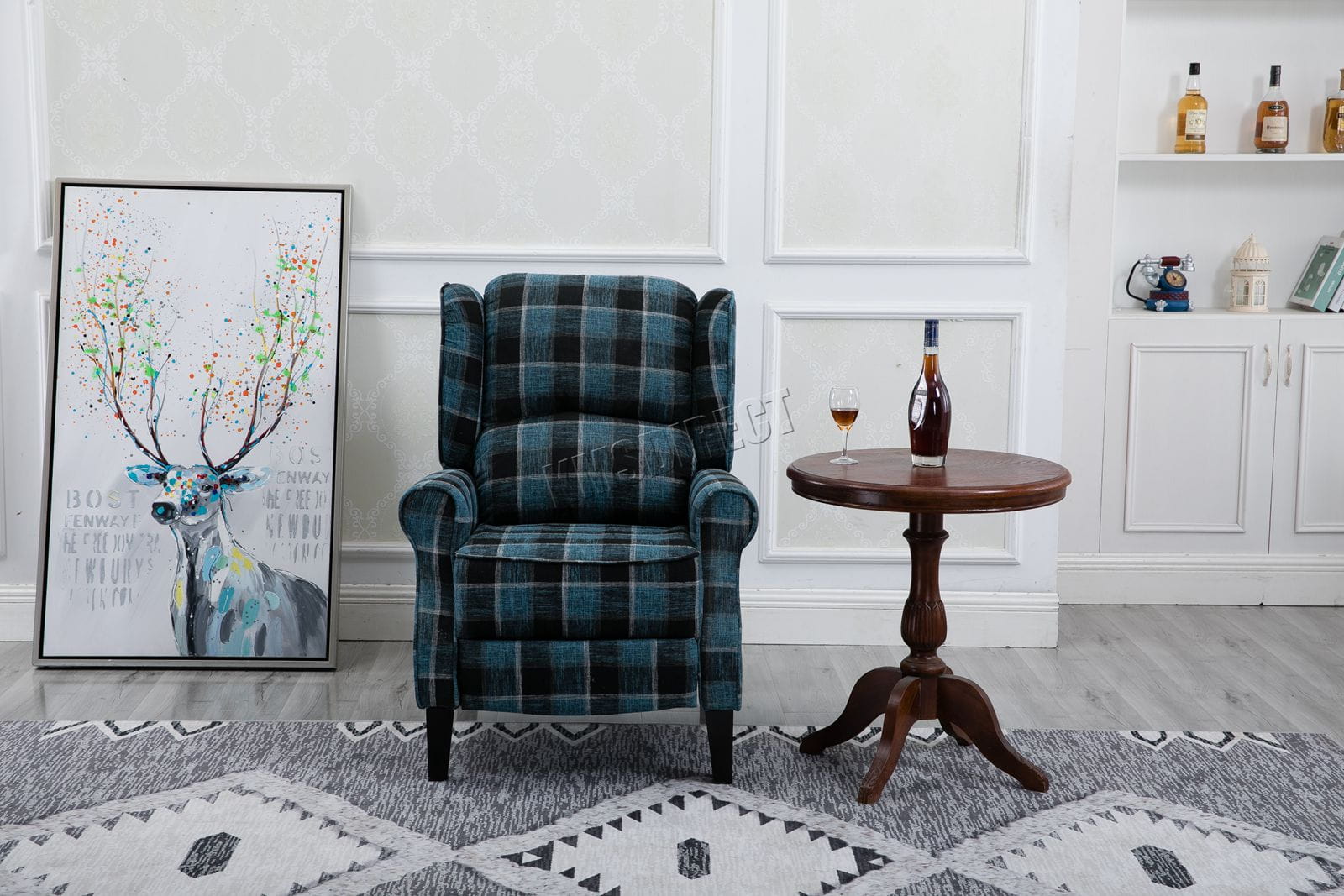 Blue checkered recliner armchair in a room with a decorative deer painting and a small table.