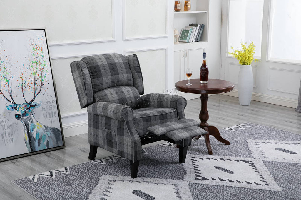 Grey checkered recliner armchair in a living room setting with a small table and decorative items.