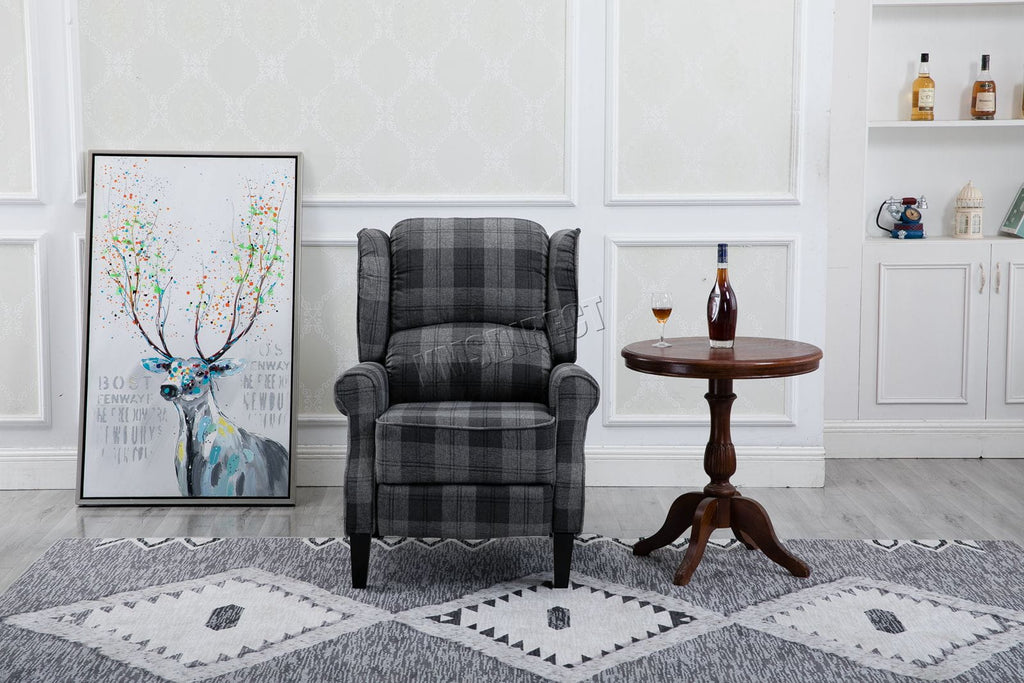 Grey checkered recliner armchair in a living room with a decorative painting and side table.