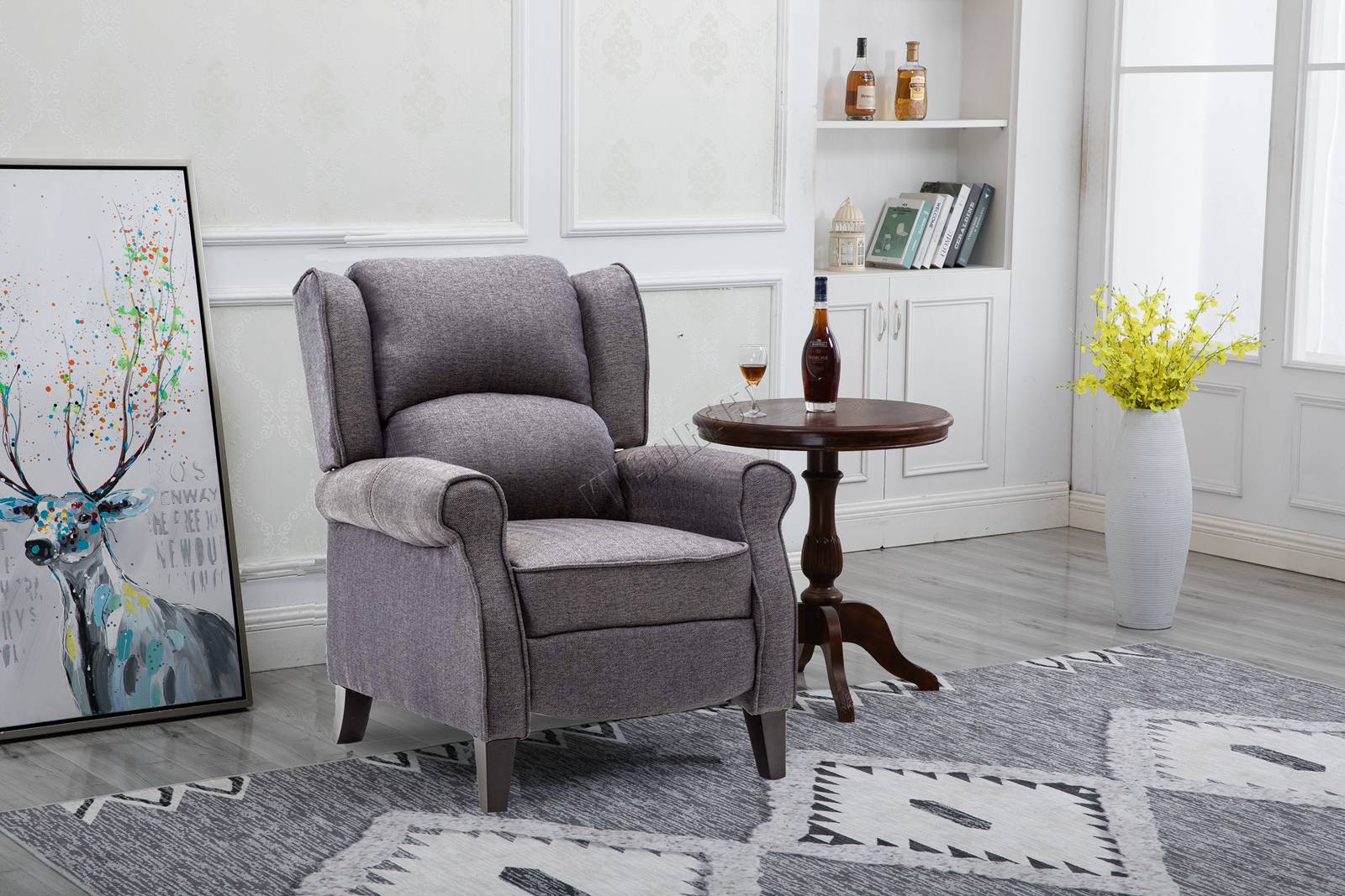 Grey recliner armchair in a living room setting with a side table and decorative items.
