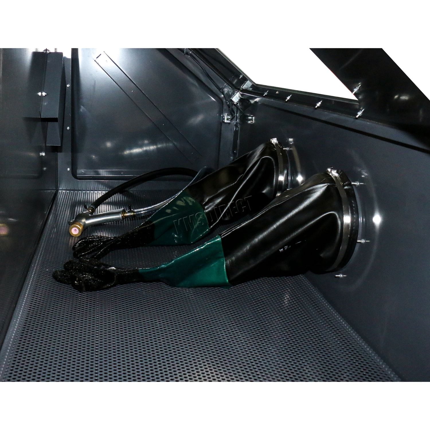 Close-up of a vinyl gloves inside of a sandblasting machine