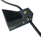Black metal foot pedal of a sandblasting machine with a gold button and cable on a white background