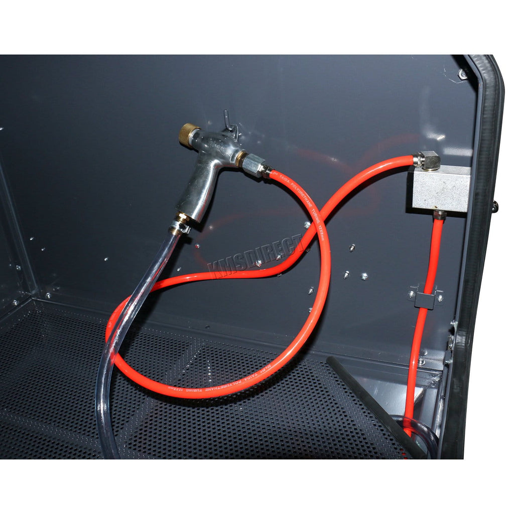 Spray gun with red hose attached to a black surface