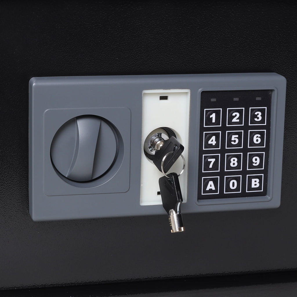 Security safe with digital keypad and key slot on a black background
