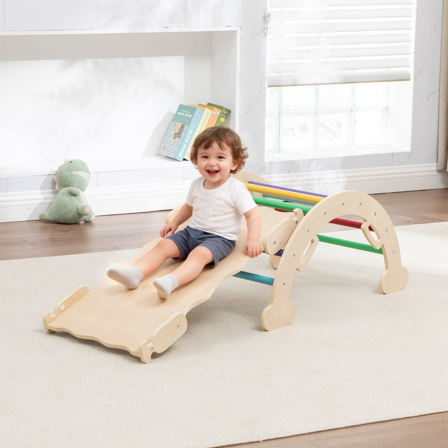 child using the reversible slide on a small climbing frame.