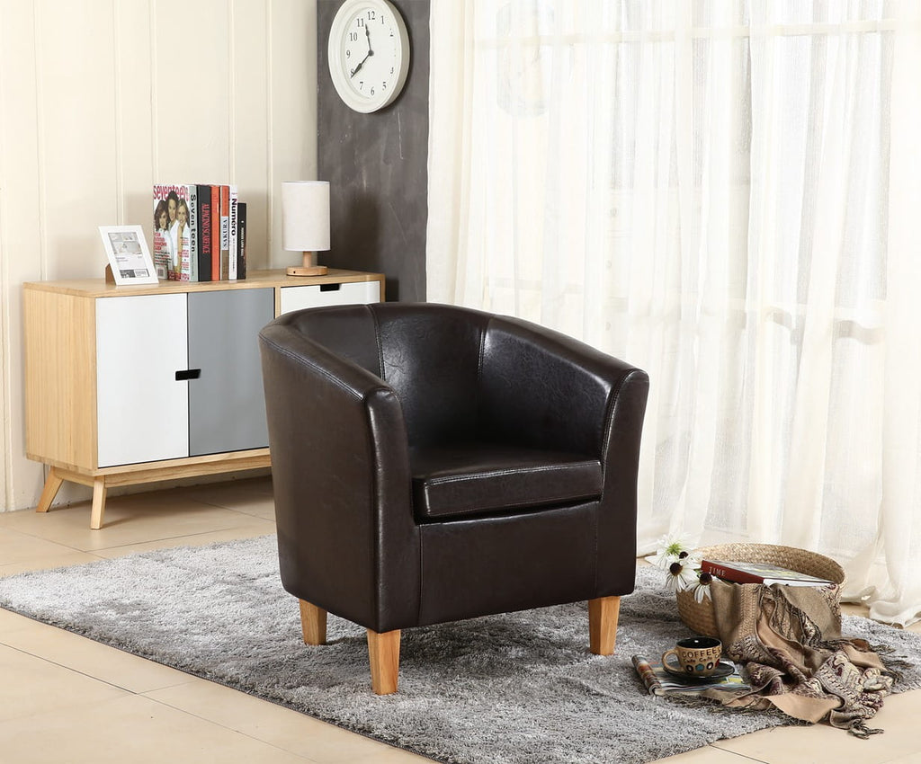 Brown faux leather armchair in a living room setting with a cabinet and clock in the background.