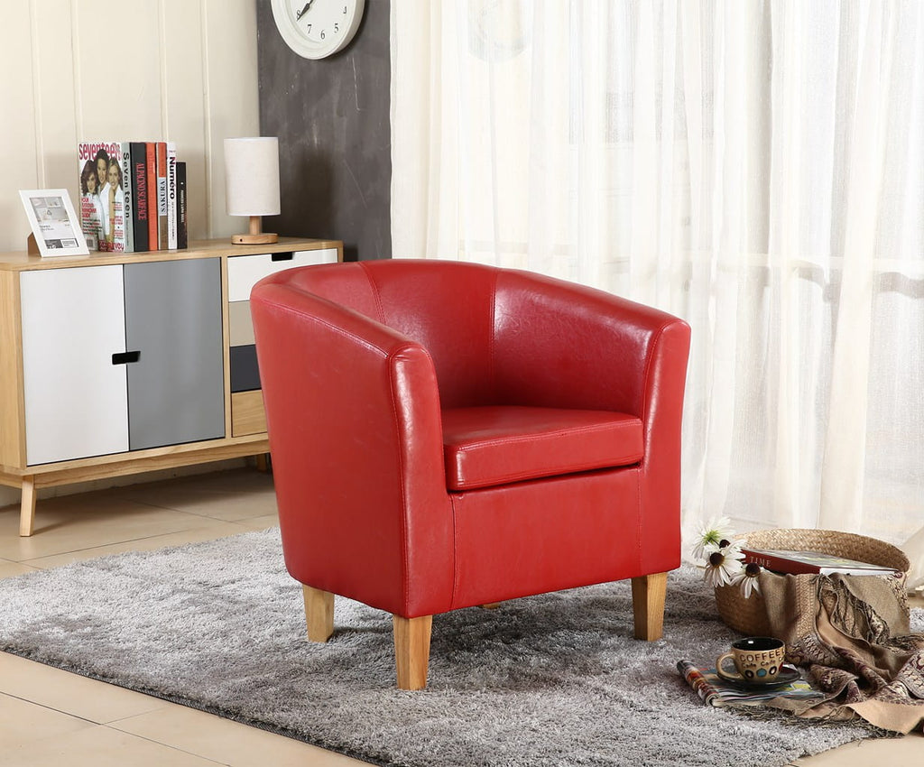 Red faux leather armchair in a living room setting with a cabinet and decor items.