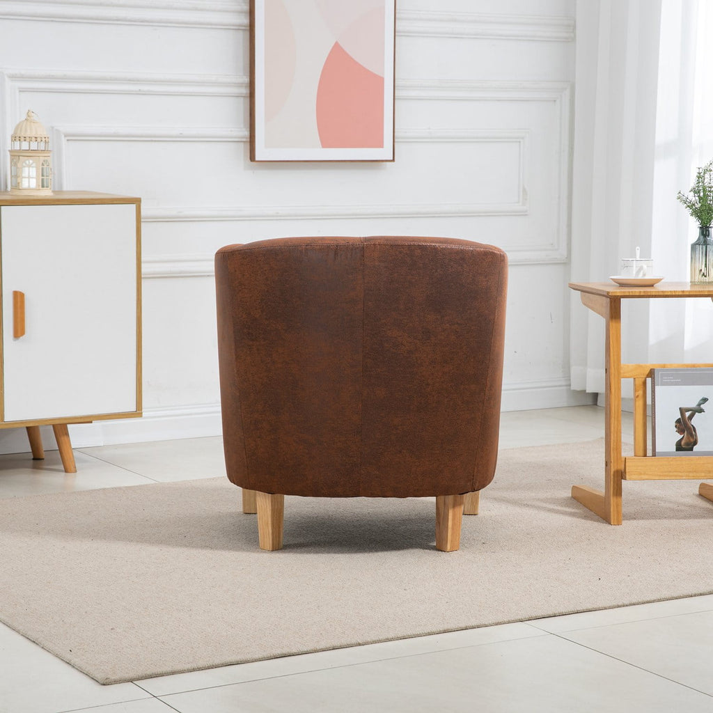 Vintage brown faux leather armchair in a room with white walls and wooden furniture.
