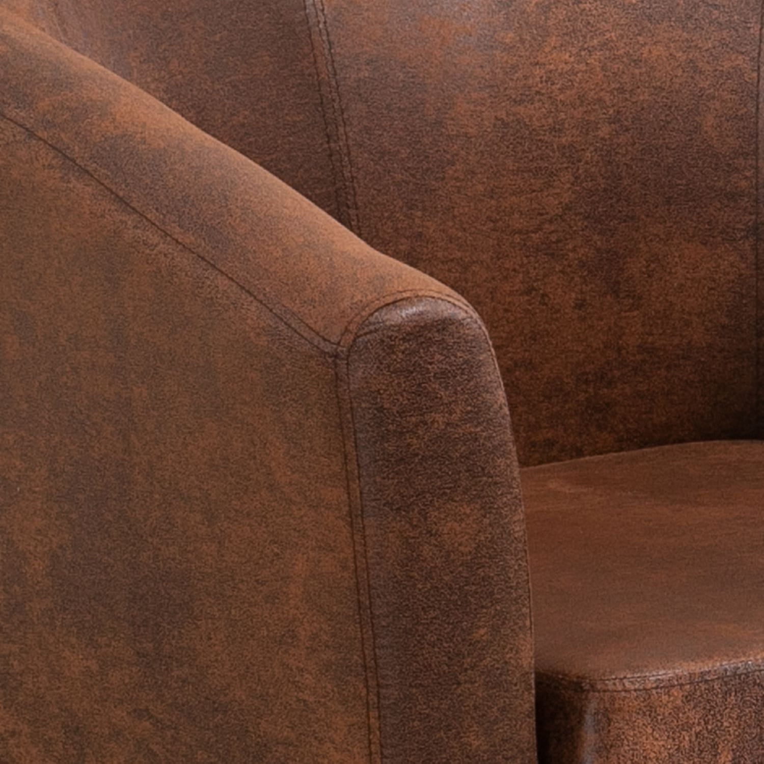 Close-up of a vintage brown faux leather armchair