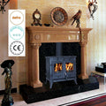 Wood-burning multi-fuel stove in a fireplace with decorative items and certification logos displayed.