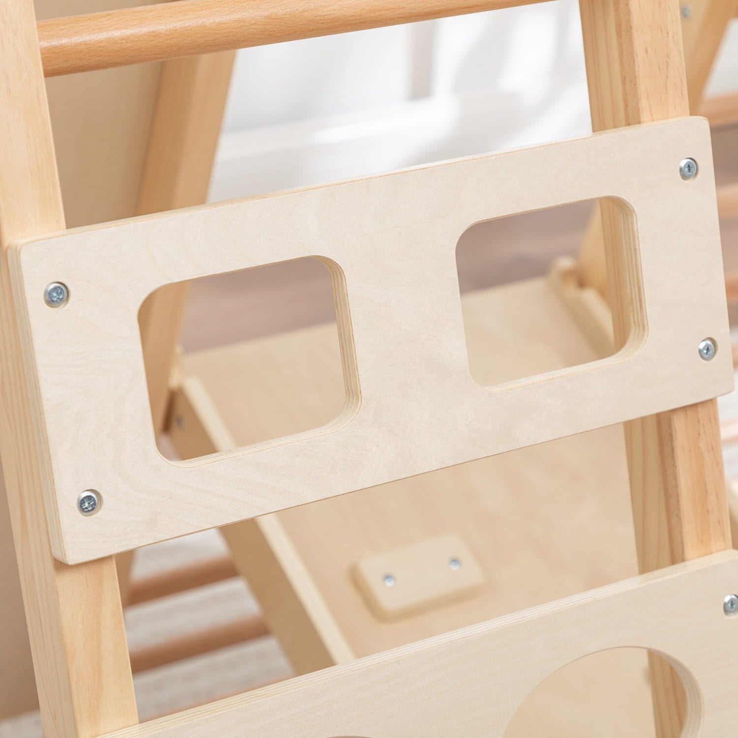 ladder from a wooden climbing frame with two large grips.