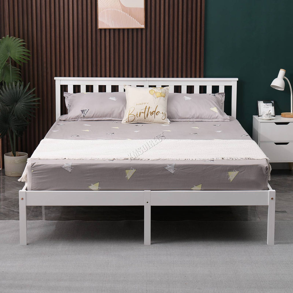 White wooden double bed frame with grey bedding and pillows in a bedroom setting.