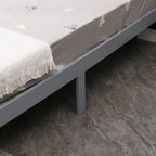 Grey bed frame with mattress on a tiled floor from the wooden double bed.