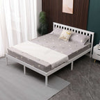 White wooden double bed frame with grey bedding in a bedroom setting.