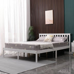 White wooden double bed frame with mattress in a bedroom setting