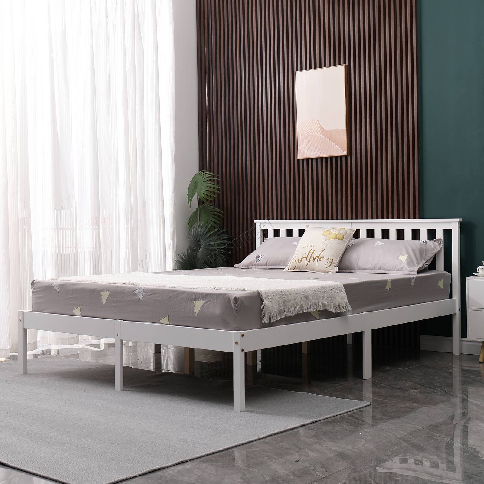 White wooden double bed frame with mattress in a bedroom setting