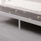 Grey mattress with a white frame from the wooden double bed on a grey carpeted floor