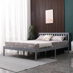 Grey wooden double bed frame with mattress in a bedroom setting.
