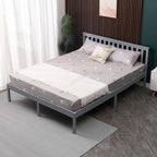 Grey wooden double bed frame with mattress and bedding in a room setting. 